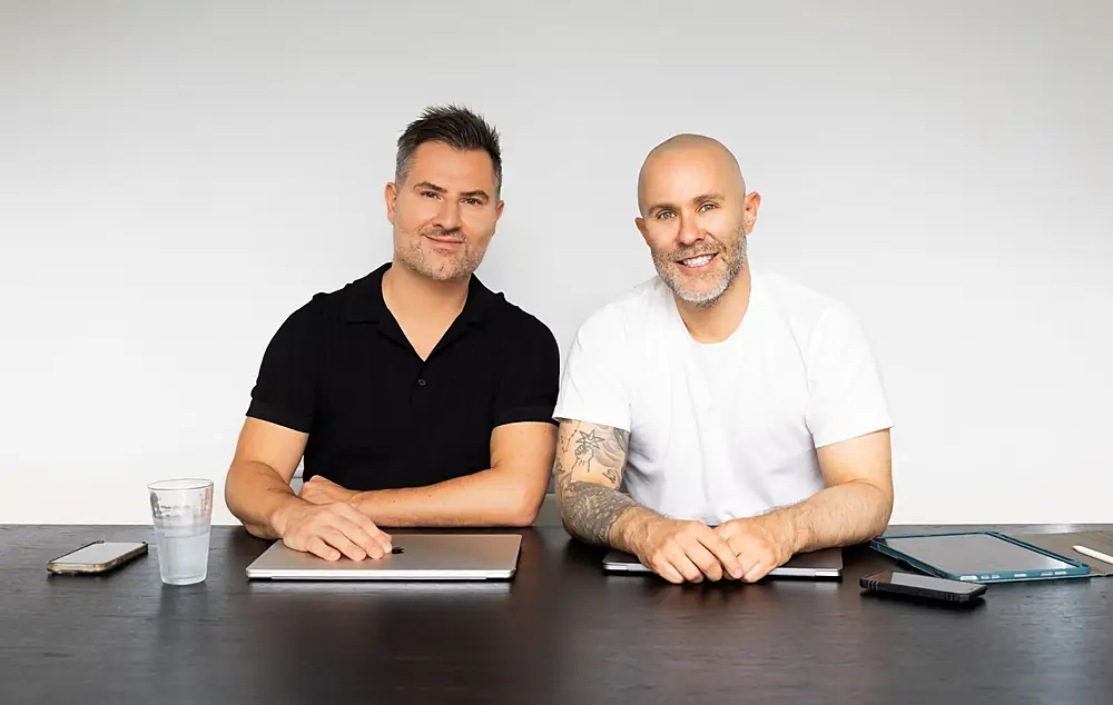 Dr Jake Sloane and David Segal, co-founders of Inside Aesthetics, sitting together at a table
